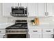 Stainless steel gas range and microwave in a modern kitchen setting at 14866 W Windsor Ave, Goodyear, AZ 85395