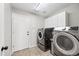 Laundry room with washer, dryer, and cabinets at 14866 W Windsor Ave, Goodyear, AZ 85395