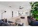 Open living room with hardwood floors and access to the kitchen at 14866 W Windsor Ave, Goodyear, AZ 85395