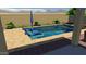 Relaxing pool area with patio furniture and mountain views at 14866 W Windsor Ave, Goodyear, AZ 85395
