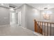 Upstairs hallway with light wood flooring, two doors, and a wooden staircase at 14866 W Windsor Ave, Goodyear, AZ 85395