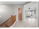Upstairs hallway with wood-look floors and access to bedrooms at 14866 W Windsor Ave, Goodyear, AZ 85395