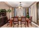 Dining room with a wood table and six chairs, hardwood floors, and large windows at 15244 W Alexandria Way, Surprise, AZ 85379