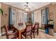 Bright dining room with a large table, hardwood floors, and large windows at 15244 W Alexandria Way, Surprise, AZ 85379