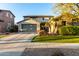 Two-story house with stone accents, landscaping, and a large driveway at 15244 W Alexandria Way, Surprise, AZ 85379