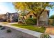 Two-story house with stone accents and a tree in front at 15244 W Alexandria Way, Surprise, AZ 85379