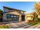 Two-story house with a green door, landscaping, and a large driveway at 15244 W Alexandria Way, Surprise, AZ 85379