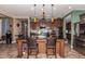 Kitchen with dark wood cabinets, granite countertops, and a large island at 15244 W Alexandria Way, Surprise, AZ 85379