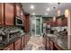 Open kitchen featuring dark wood cabinets and a large island at 15244 W Alexandria Way, Surprise, AZ 85379