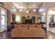 Spacious living room with hardwood floors, large windows and a sectional sofa at 15244 W Alexandria Way, Surprise, AZ 85379