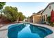 Relaxing kidney shaped pool with lounge chairs at 15244 W Alexandria Way, Surprise, AZ 85379