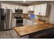 Spacious kitchen with butcher block countertops and stainless steel appliances at 156 N Hawes Rd # 75, Mesa, AZ 85207