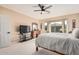 Spacious bedroom with large window, ceiling fan and dresser at 16983 W Desert Blossom Way, Surprise, AZ 85387