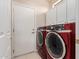 Laundry room with washer, dryer, and cabinets at 16983 W Desert Blossom Way, Surprise, AZ 85387