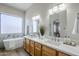 Elegant bathroom features a soaking tub, double vanity, and marble tile accents at 17421 E Via Del Oro --, Fountain Hills, AZ 85268