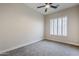 Bright bedroom with ceiling fan, gray carpet, and window shutters at 17421 E Via Del Oro --, Fountain Hills, AZ 85268