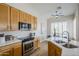 Bright kitchen boasts light wood cabinets, stainless steel appliances, and ample counter space at 17421 E Via Del Oro --, Fountain Hills, AZ 85268