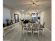 Elegant dining room features a chandelier and seating for six at 17429 W Country Club Ter, Surprise, AZ 85387