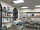 Bright art studio with tables, chairs, and ample shelving for supplies and artwork at 17531 W Liberty Ln, Goodyear, AZ 85338