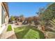 Landscaped backyard with putting green and patio area at 17531 W Liberty Ln, Goodyear, AZ 85338