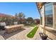 Spacious patio with fire pit, putting green, and lush landscaping at 17531 W Liberty Ln, Goodyear, AZ 85338