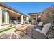Relaxing backyard patio with fire pit, seating area, and built-in grill at 17531 W Liberty Ln, Goodyear, AZ 85338
