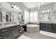 Elegant bathroom with a large soaking tub and double vanity at 17531 W Liberty Ln, Goodyear, AZ 85338