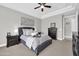Spacious bedroom with dark wood furniture and a ceiling fan at 17531 W Liberty Ln, Goodyear, AZ 85338