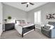 Bright bedroom with a queen-size bed and a ceiling fan at 17531 W Liberty Ln, Goodyear, AZ 85338