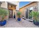 Private courtyard with a welcoming entryway and lush plants at 17531 W Liberty Ln, Goodyear, AZ 85338