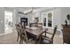 Open dining room with a wooden table and view into the kitchen and office at 17531 W Liberty Ln, Goodyear, AZ 85338