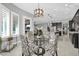 Open concept dining area with glass table and view into kitchen at 17531 W Liberty Ln, Goodyear, AZ 85338