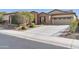 Single-story home with stone accents and a two-car garage at 17531 W Liberty Ln, Goodyear, AZ 85338