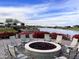 Cozy fire pit with seating overlooking a lake at 17531 W Liberty Ln, Goodyear, AZ 85338