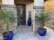 Front entrance with dark brown door and blue pots at 17531 W Liberty Ln, Goodyear, AZ 85338