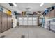 Garage with overhead storage racks and ample floor space at 17531 W Liberty Ln, Goodyear, AZ 85338
