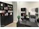 Home office with large desk, built-in shelving, and comfortable chair at 17531 W Liberty Ln, Goodyear, AZ 85338
