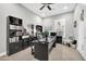 Bright home office features a large desk, built-in shelving and ceiling fan at 17531 W Liberty Ln, Goodyear, AZ 85338