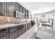 Modern kitchen with dark wood cabinets, granite countertops and tile backsplash at 17531 W Liberty Ln, Goodyear, AZ 85338
