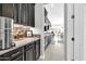 Kitchen features dark cabinetry, granite counters, and stainless steel appliances at 17531 W Liberty Ln, Goodyear, AZ 85338