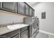 Laundry room with washer, dryer, and upper cabinets at 17531 W Liberty Ln, Goodyear, AZ 85338