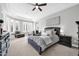 Main bedroom with plush bed, large windows, and ample closet space at 17531 W Liberty Ln, Goodyear, AZ 85338