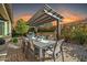 Outdoor kitchen and dining area with pergola at 17531 W Liberty Ln, Goodyear, AZ 85338
