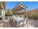 Outdoor kitchen and dining area with pergola at 17531 W Liberty Ln, Goodyear, AZ 85338