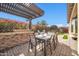 Outdoor kitchen with stone bar and pergola at 17531 W Liberty Ln, Goodyear, AZ 85338