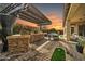 Outdoor kitchen and dining area with pergola at 17531 W Liberty Ln, Goodyear, AZ 85338