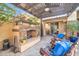 Relaxing patio with fireplace, seating area, and pergola at 17531 W Liberty Ln, Goodyear, AZ 85338