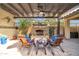 Covered patio with fireplace and comfortable seating at 17531 W Liberty Ln, Goodyear, AZ 85338
