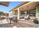 Covered patio with seating and dining areas at 17531 W Liberty Ln, Goodyear, AZ 85338