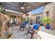 Peaceful patio with pergola, fireplace, and comfortable seating at 17531 W Liberty Ln, Goodyear, AZ 85338